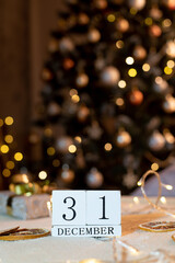 calendar with the date December 31 on the background of candles and Christmas decor in gold color