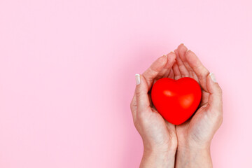 Woman hands holding red heart - obrazy, fototapety, plakaty