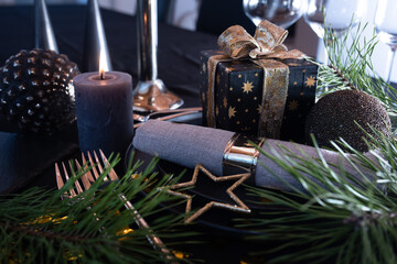 Atmospheric table decoration for a christmas or new year dinner. Place setting in modern style....
