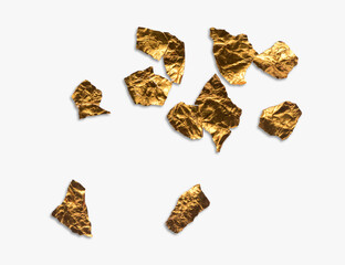 Shiny pieces of crumpled and creased gold foil or leaf isolated on a white background.
