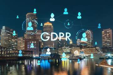 City view panorama of Boston Harbour and Seaport Blvd at night time, Massachusetts. Building exteriors of financial downtown. GDPR hologram is data protection regulation, privacy for all individuals