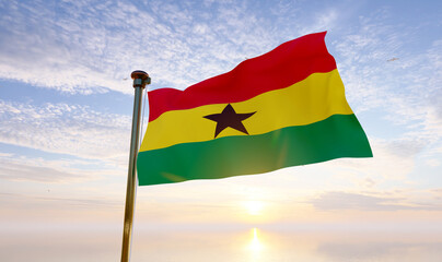 Flag of Ghana waving in the wind, sky and sun background. Ghana Flag 3d rendering.