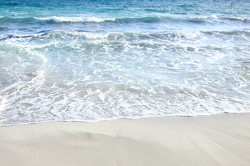 Sand beach, summer sea water with wave. Cala azzurra beach, Favignana island, Sicily, Italy. Wet sand on empty beach