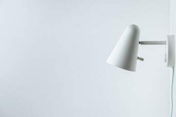 White wall lamp on white wall background. Saving energy. Living during blackout concept. Copy space...