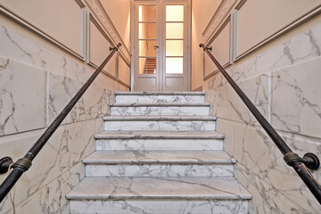 Marble stairs in renovated mansion stairwell