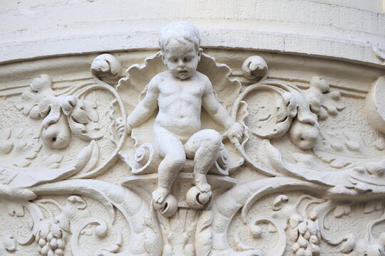 Amsterdam Spui Square White Sculpted Building Detail Depicting a Child Sitting on a Shell, Netherlands