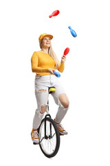 Young female riding a mono cycle and juggling