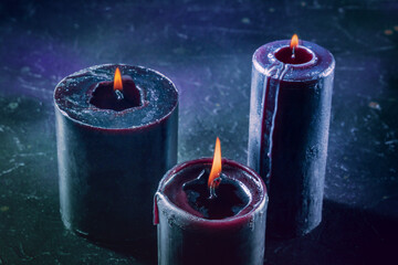 Burning candles on a dark background, mysterious ritual
