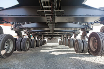 The chassis of a large truck crane. Wheelbase of the crane. Many wheels on the crane.