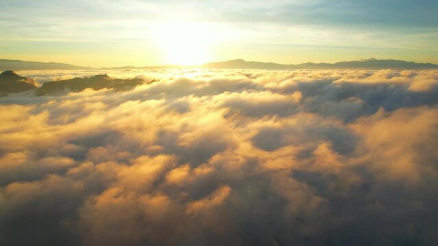 Drone flying over heavy dense fog during sunrise, Mountain scenery and sky in the background. amazing scenery in golden hour. Mae Hong Son Province, Northern Thailand. nature and travel concept. 4K
