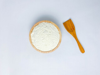 Fototapeta na wymiar A wooden bowl of flour.