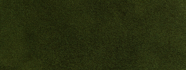 Texture of velvet matte dark green background, macro. Suede olive fabric with pattern. Textile leather backdrop,
