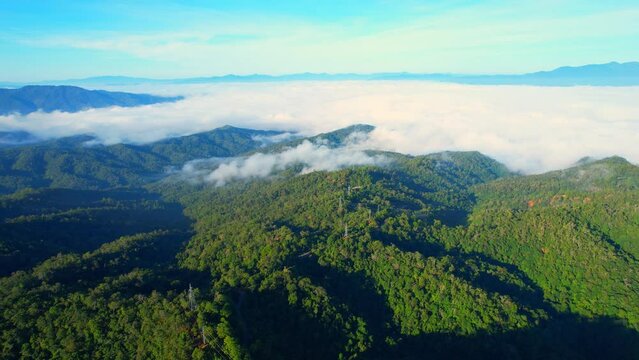 Aerial view over dense fog and beautiful mountains during sunrise. landscape of tropical rainforest in winter. Pai District, Mae Hong Son Province, Northern Thailand. travel and nature concept. 4K
