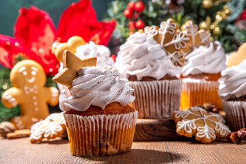 Christmas gingerbread cupcakes. Sweet chocolate and white muffin cupcakes with whipped cream,...