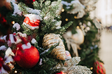 Close up of balls on christmas fir tree. Bokeh light garlands in background with copy space. Merry christmas and happy new year