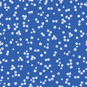 Cute floral pattern. Seamless vector texture. An elegant template for fashionable prints. Print with small white flowers. blue background.