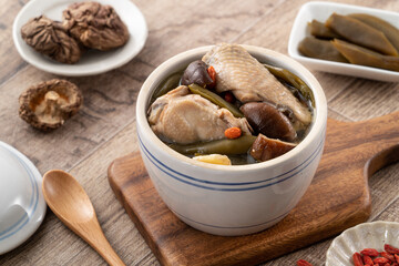 Delicious Taiwanese peeled green chili pepper chicken soup with mushroom and goji berry.