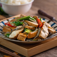 Homemade stir-fried dried beancurd with dried fish and green chili.