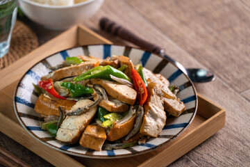 Homemade stir-fried dried beancurd with dried fish and green chili.