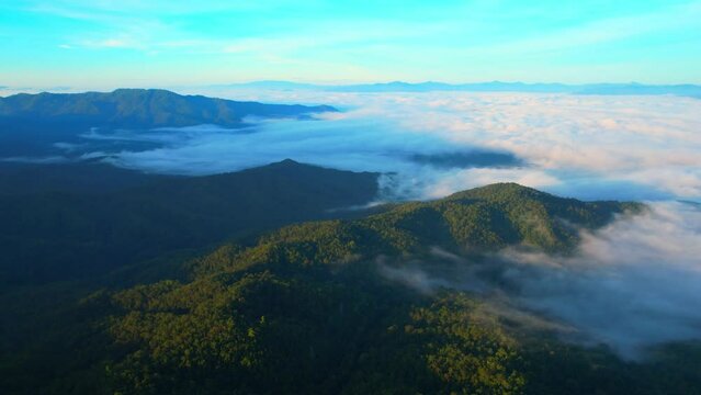 Aerial view over dense fog and beautiful mountains during sunrise. landscape of tropical rainforest in winter. Pai District, Mae Hong Son Province, Northern Thailand. travel and nature concept. 4K
