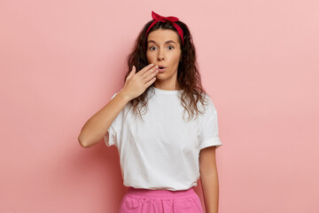 Woman reaction on sudden news, isolated over pink wall