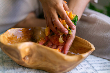 Young woman intentionally making flower infused herbal bath