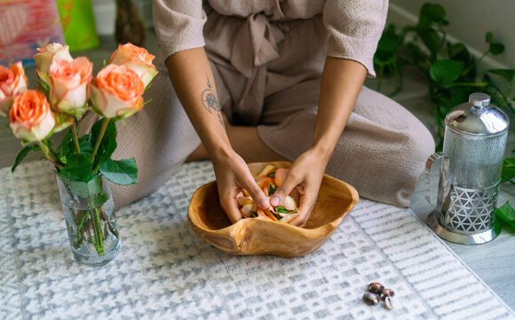 Young woman intentionally making flower infused herbal bath