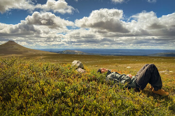 Man resting on hiking trip. Nipfjället nature reserve. Mountains in Idre, Sweden.