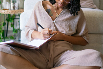 Young woman journaling in her home