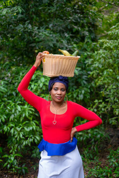 Caribbean woman with produce basket on head