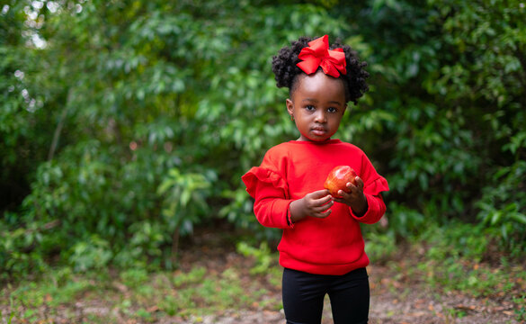 Toddler eating fruit at park