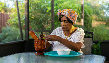 Woman using mortar and pestle to make dinner 