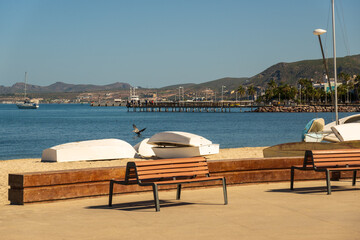 Pelicans, dingies and benches along the Malecon a popular place for evening strolls, biking and inline skating with locals and visitors alike in La Paz, Baja de California Sur, Mexico	
