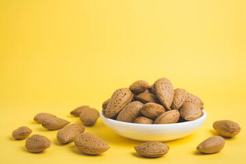 almonds in a plate on a yellow