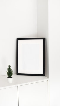 Minimalist black white picture frame with Christmas tree decor. Interior poster mock-up