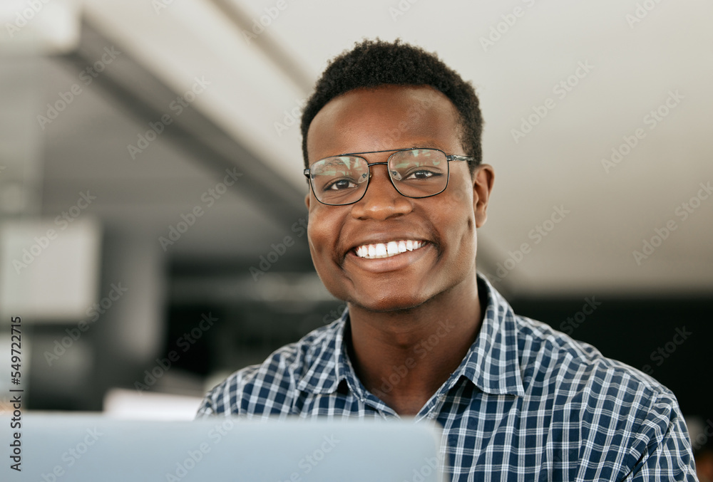 Poster Portrait, laptop and it support with a black man working in his office as an engineer or technician. Face, happy and smile with a nerd or geek at work in information technology or internet security