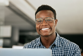 Portrait, laptop and it support with a black man working in his office as an engineer or technician. Face, happy and smile with a nerd or geek at work in information technology or internet security - obrazy, fototapety, plakaty
