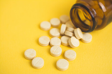 headache pills isolated on yellow