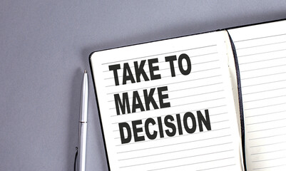 TAKE TO MAKE DECISION word on the notebook with pen