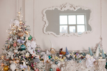 Christmas and New Year card with decorated fur tree and stucco mirror on white wall background.
