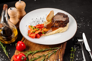 Fresh tasty steak with mashed potatoe and boiled vegetables on wooden background