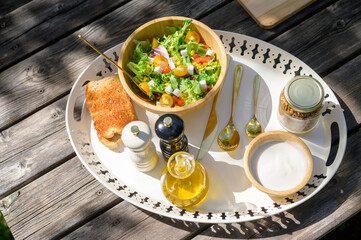 Delicious healthy breakfast served on wooden table in garden