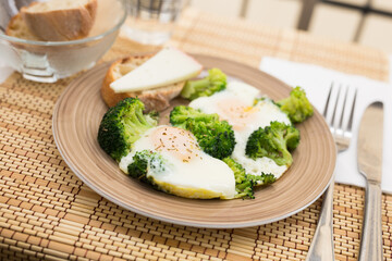 breakfast of crumpled eggs with broccoli