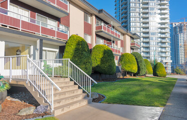 Small porch with steps to the entrance at low rise residential building