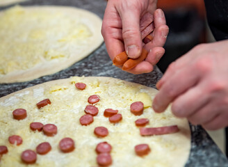 Closeup hand of chef baker making pizza at kitchen. The process of making pizza. cooking italian pizza