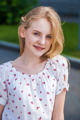 Close-up portrait of a teenage girl in white dress