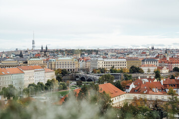 Fototapeta premium Prague cityscape with view of Nicholas Cathedral and orange building roofs in autumn