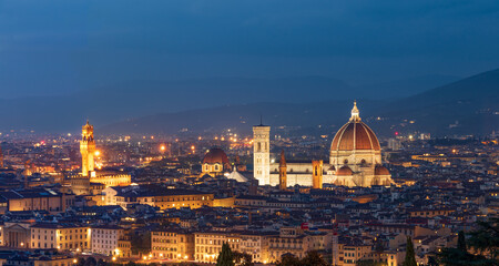 Fototapeta na wymiar A panoramic view of the roofs and domes of the cathedrals of evening Florence from the upper viewing platform