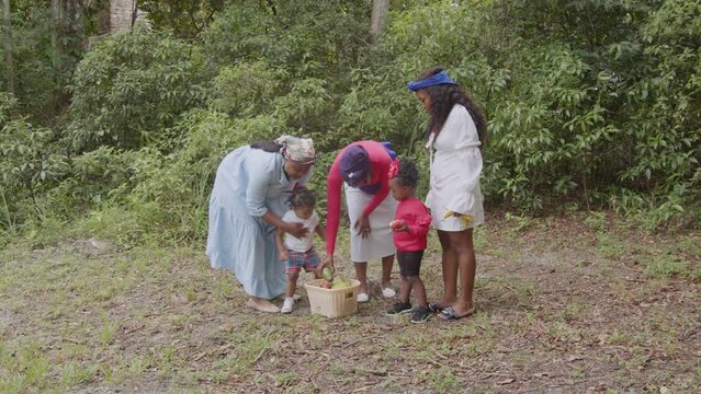Woman teaching children about fruits and vegetables