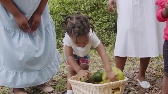 Toddler son playing with fruit basket